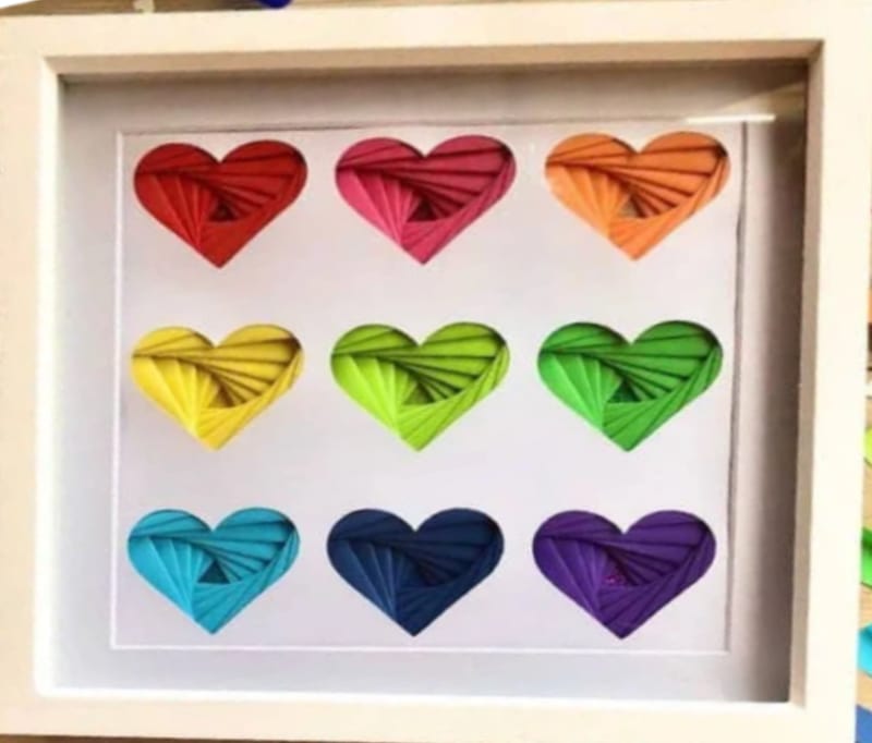 Framed grid of nine rainbow iris-folded hearts